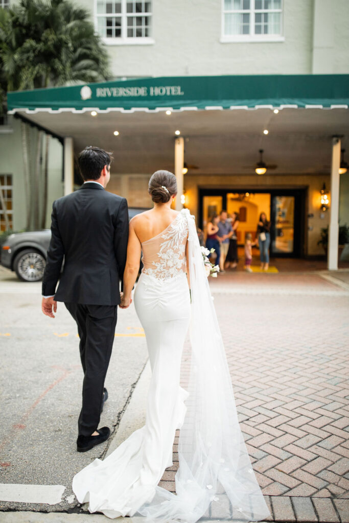 bride and groom entering their riverside hotel wedding