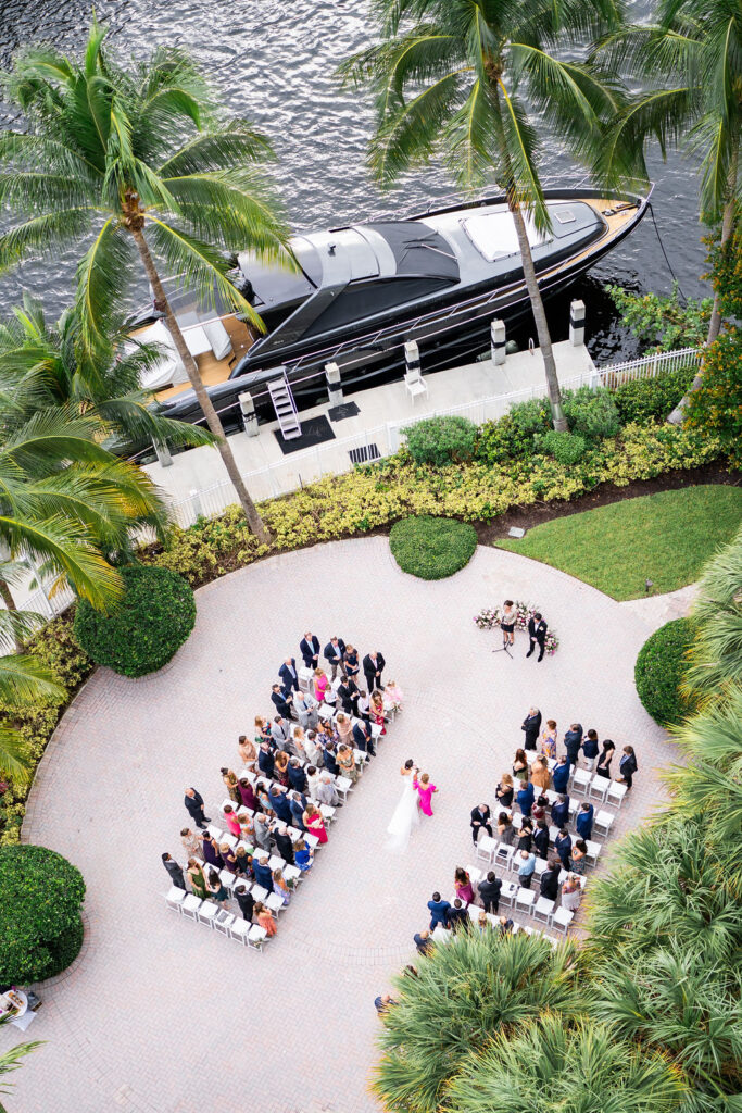 a birdseye view of the ceremony taking place at the riverside patio at Riverside Hotel wedding