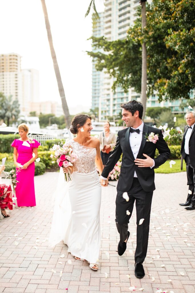 bride and groom exiting ceremony at their riverside hotel wedding