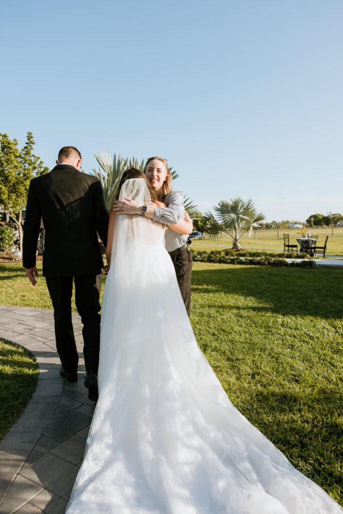 certified wedding planner megan ashley events hugging bride after ceremony