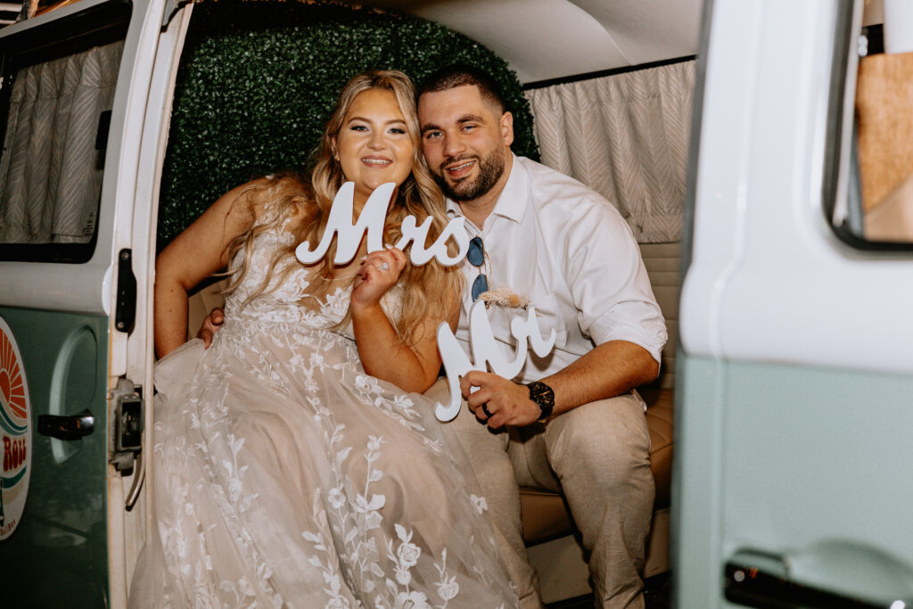 bride and groom enjoying photo bus at bamboo gallery wedding