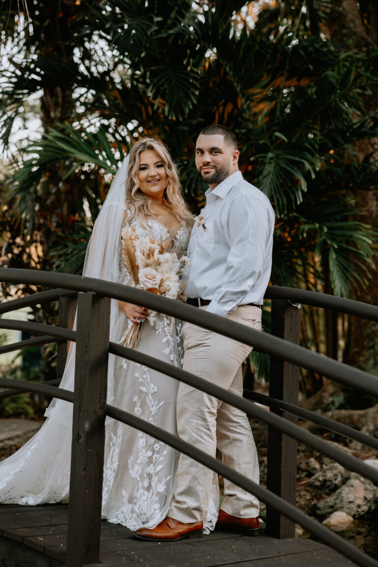 Bride and Groom standing on bridge at Bamboo Gallery wedding in Davie, Florida